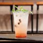 Lemonade with mint and currants in a plastic disposable cup on table